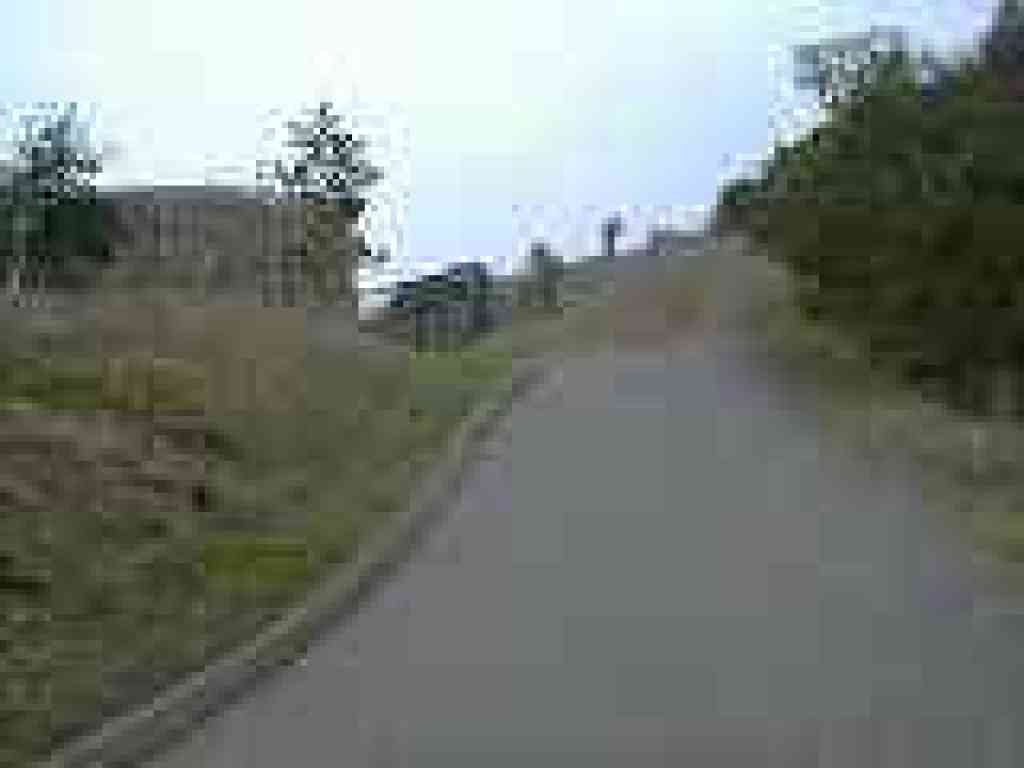 Trail evolves into dirt past the water tank