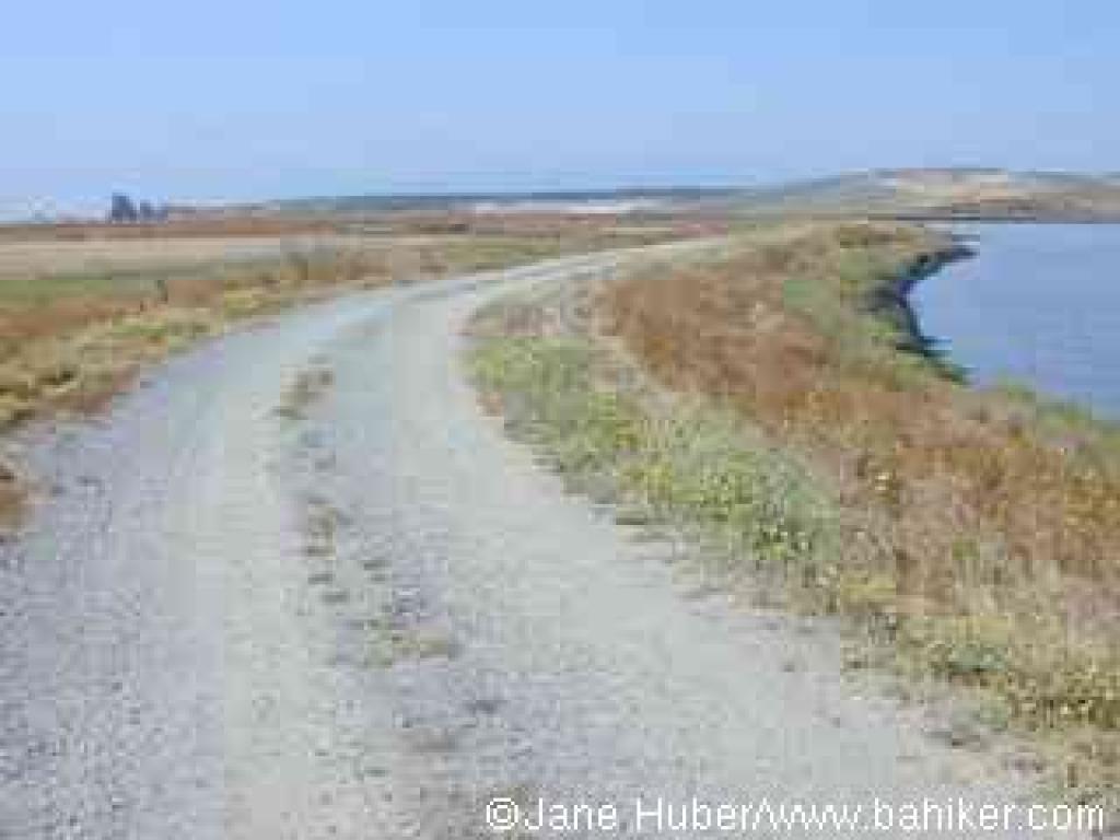 Leaving the parking lot, the trail starts out along a levee